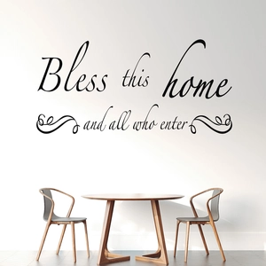 Elegant black cursive Bless This Home wall decal shown above a dining table set