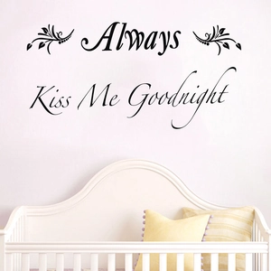 Always Kiss Me Goodnight black PVC wall decal with vine accents above a baby crib