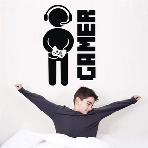 Detail view of a black gamer silhouette wall decal on a white bedroom wall