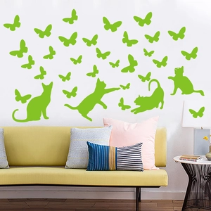 Luminous green cat and butterfly wall stickers applied in a modern living room setting