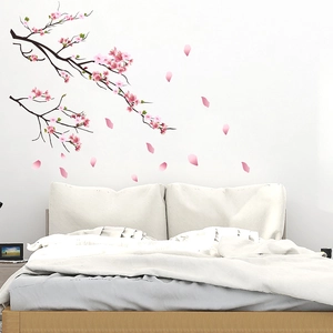 Detail of pink cherry blossom wall decals showing branches and falling petals for bedroom
