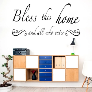 Detail view of Bless this home and all who enter black vinyl wall decal in a cozy room