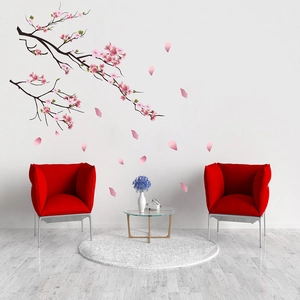 Detailed view of plum blossom wall stickers with falling petals in a modern living room