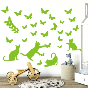Luminous cat and butterfly wall stickers in a cozy child room with wooden decor