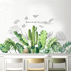 Detail of tropical plant wall stickers featuring monstera leaves and artistic quotes