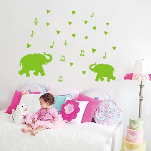 Luminous green cartoon elephant and music notes wall decals for a cozy nursery bedroom