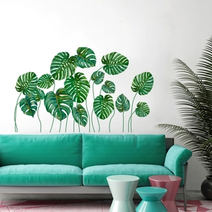 Detailed view of tropical monstera leaf wall decals on a living room wall