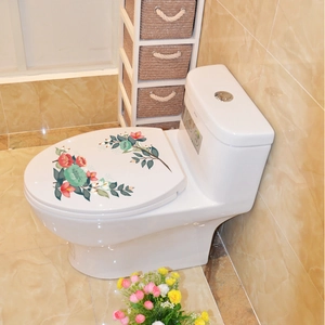 Détail d'autocollants floraux pour abattant de WC avec fleurs rouges et vertes