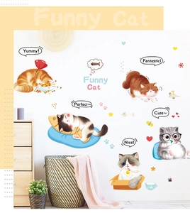 Detail showing various cute cartoon cat wall decals applied on a bedroom cabinet surface