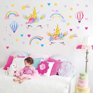 Detailed close-up of rainbow unicorn wall stickers with gold stars for kids room decor
