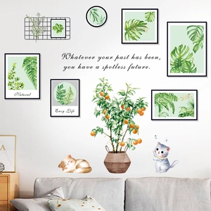 Detail of botanical wall decals with green plants, cartoon cats and motivational quotes