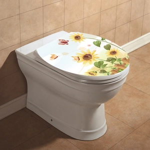 Detailed view of pastoral sunflower and butterfly decals on a white U-shaped toilet lid cover