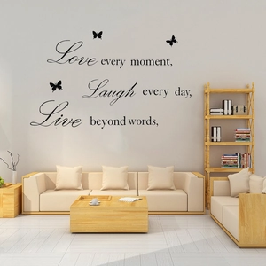 Detail showing 'Live Love' wall decal with butterflies in a modern living room