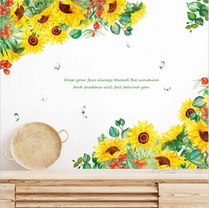 Sunflower wall decals with motivational quote on a white wall above a wooden cabinet