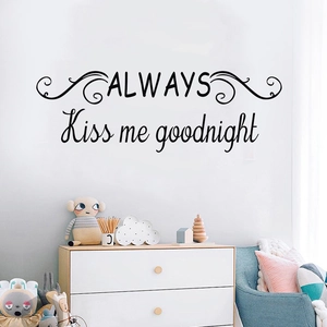 Always Kiss Me Goodnight wall decal with elegant scrolls on a nursery wall