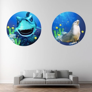 Detail of two circular ocean wall decals featuring cartoon shark and sea lion on a sofa