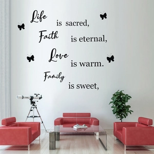 Detailed view of Live Love butterfly wall decals with inspirational quotes on living room wall