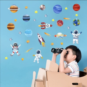 Space wall decals featuring watercolor planets and astronauts in a child's bedroom setting