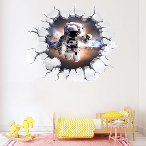 Detailed view of a 3D space astronaut wall sticker with realistic broken wall effect