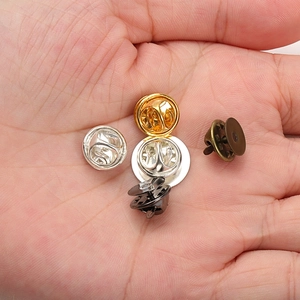 Flat head butterfly pin backs in gold, silver, bronze and black colors on palm
