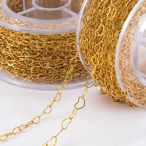 Golden stainless steel heart chain for DIY jewelry making on a transparent spool
