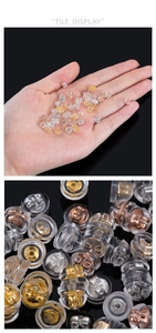 Macro view of silicone ear backings with gold, rose gold and silver butterfly inserts