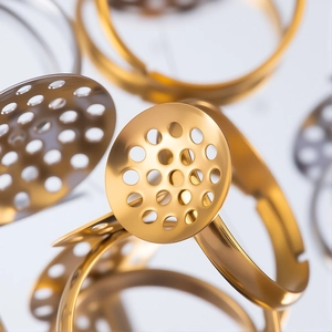 Adjustable stainless steel ring blanks with perforated round discs in gold and silver