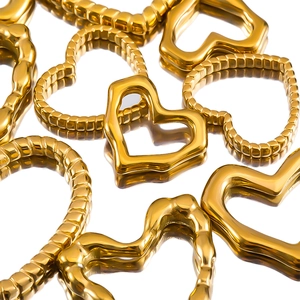 Polished heart pendants in smooth and textured gold plating on a mirror background