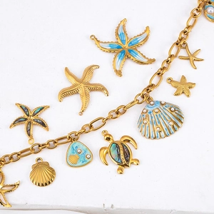 Golden ocean pendants with starfish and turtles featuring blue enamel and abalone shell