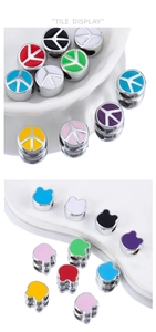 Detailed view of colorful enamel beads in peace sign and bear shapes for DIY jewelry