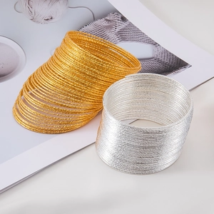 Minimalist stackable textured metal coils in gold and silver finish for DIY jewelry making