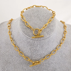 Gold stainless steel link chain necklaces with OT toggle clasp on a display bust