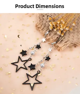 Detail of star-shaped beaded keychains with black stars and white pearls in macro view