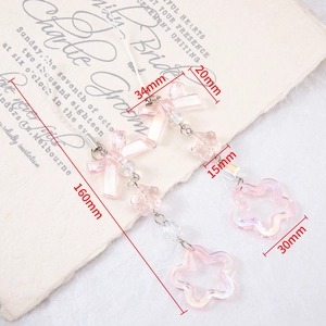 Pink heart style acrylic keychain with hollow star and bow on beige aesthetic backdrop