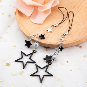 Star-themed beaded keychain set with black stars and grey pearls on a wooden tray