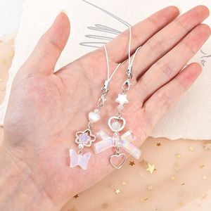 Y2K style heart and star bow phone charms with iridescent pearls on a white lanyard