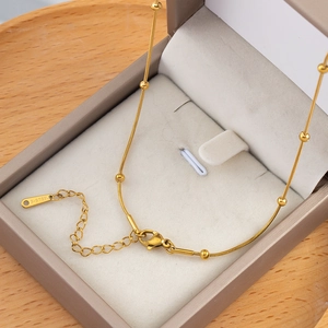Golden stainless steel snake chain bracelet with small beads and adjustable lobster clasp
