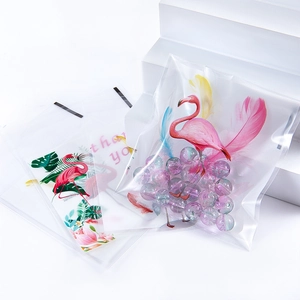 Close-up of flamingo and tropical leaf print on clear self-sealing plastic jewelry bags