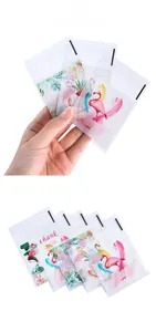Detail view of frosted plastic self-sealing bags with pink flamingo and floral prints