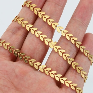 Golden stainless steel 6mm leaf chain for DIY jewelry wrapped around hand on white background