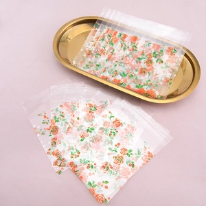 Transparent floral self-adhesive packaging bags with orange rose patterns for cookies