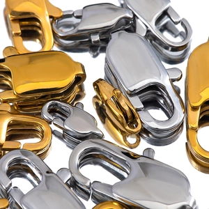 Golden and steel lobster clasps for DIY jewelry making on reflective surface