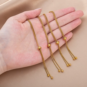 Adjustable 18K gold-plated stainless steel snake chains with sliding bead clasp held in hand
