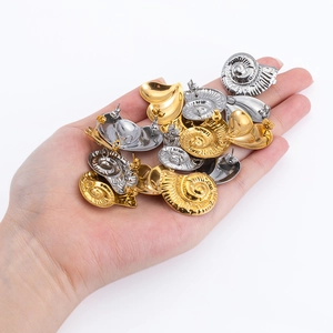 Boucles d'oreilles spirales nautilus et cœur en or et argent présentées en main