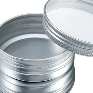 Macro detail of 40ml silver aluminum jar with screw lid, inner gasket and anti-slip ridges