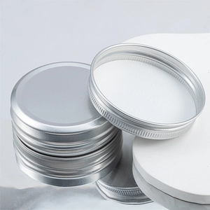 Detailed view of 40ml silver aluminum jars with screw lids and white sealing gaskets