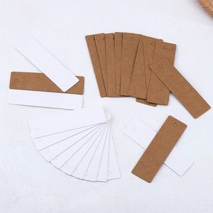 Blank kraft and white paper tags with pre-punched holes for labels and gift cards