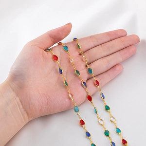 Close-up of colorful teardrop glass stones set in gold chain for DIY jewelry making