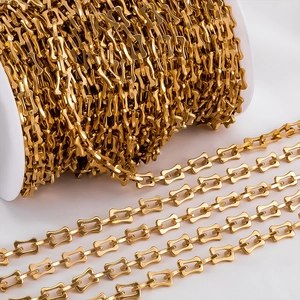 Detailed macro shot of gold rectangular hollow link chain on a large bulk spool for DIY jewelry