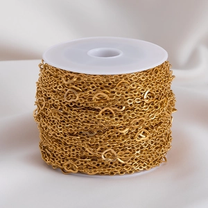 Golden stainless steel heart chain on white spool for DIY necklace and bracelet crafting